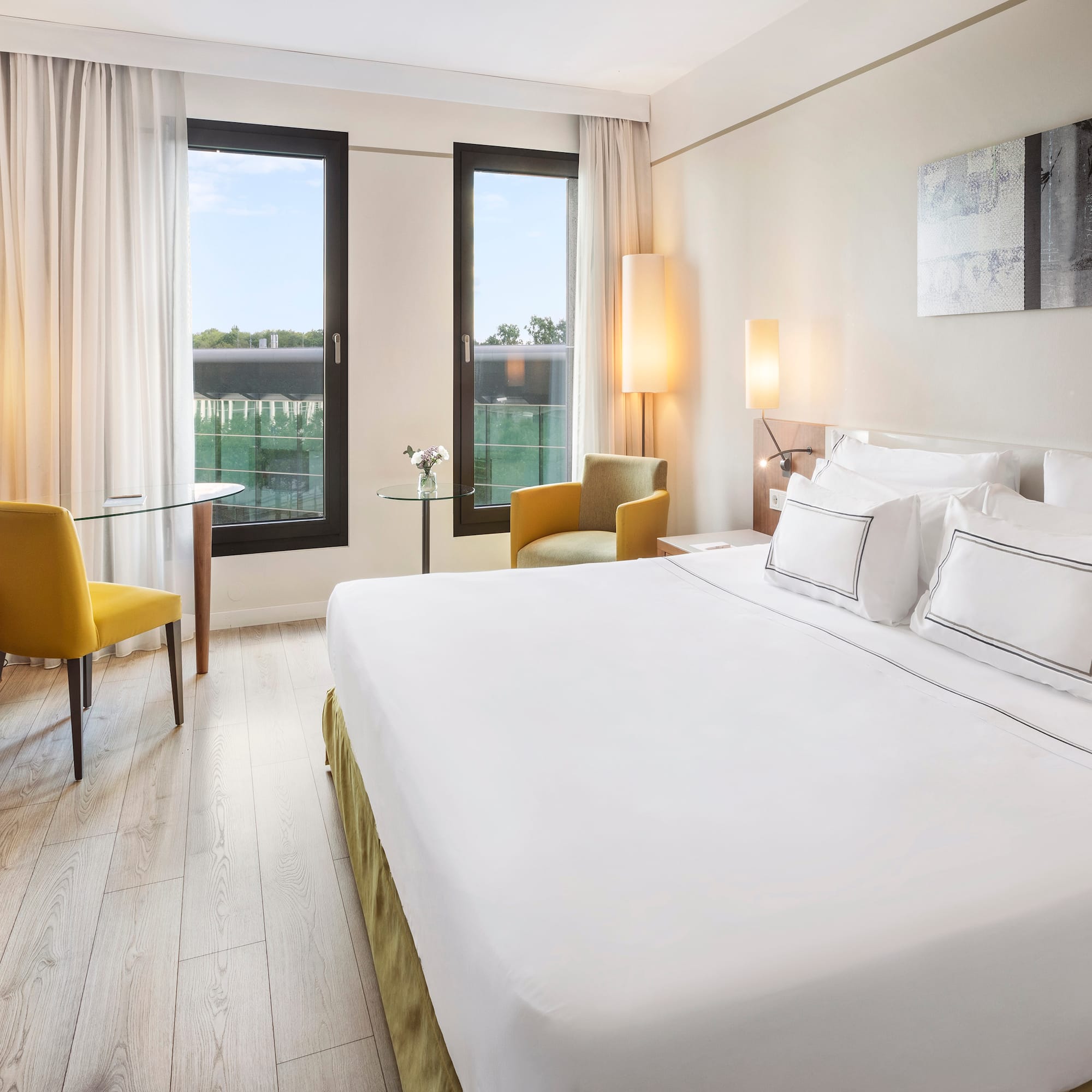 a room with a bed and chairs