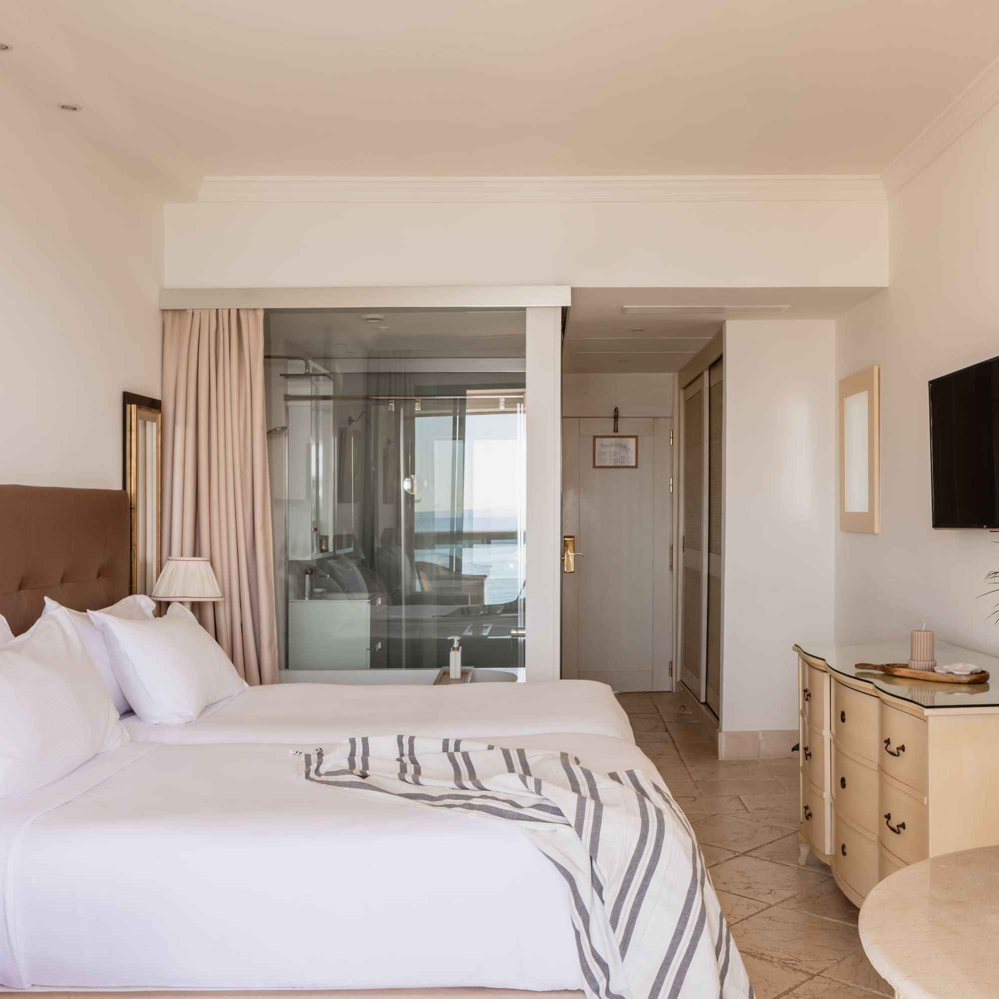 a bedroom with a television and a bed