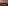 Sunset rooftop lounge overlooking city and mountains with ambient lighting.