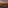 Sunset rooftop lounge overlooking city and mountains with ambient lighting.