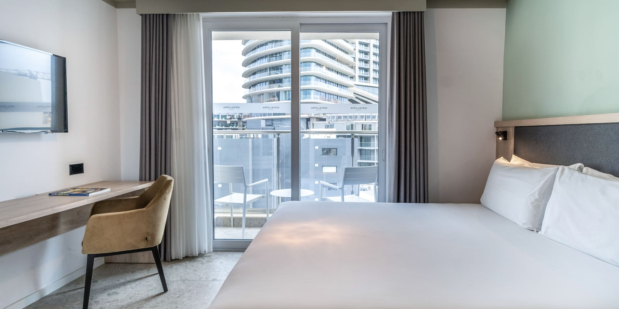 a bed in a room with a glass door