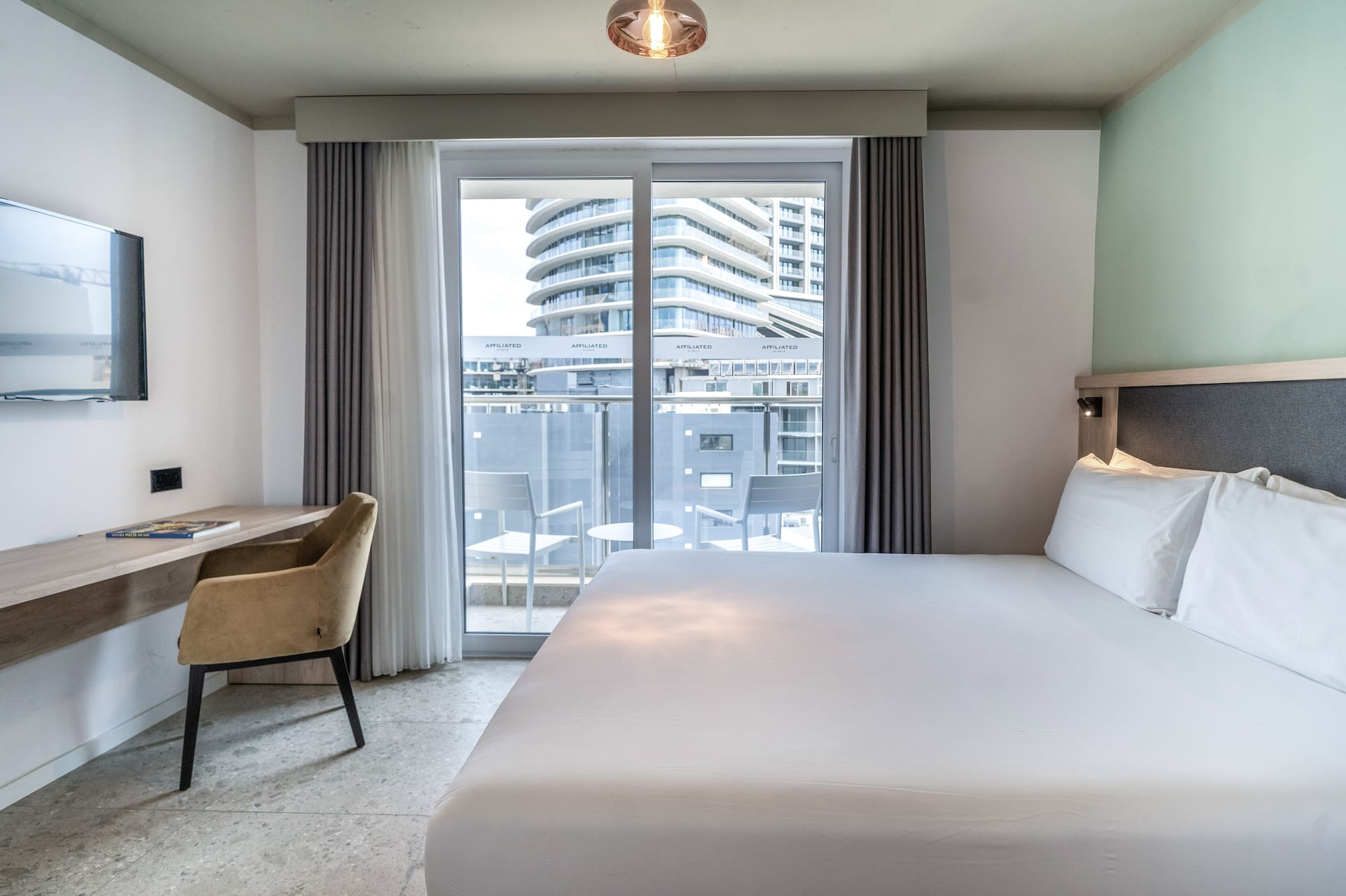 a bed in a room with a glass door