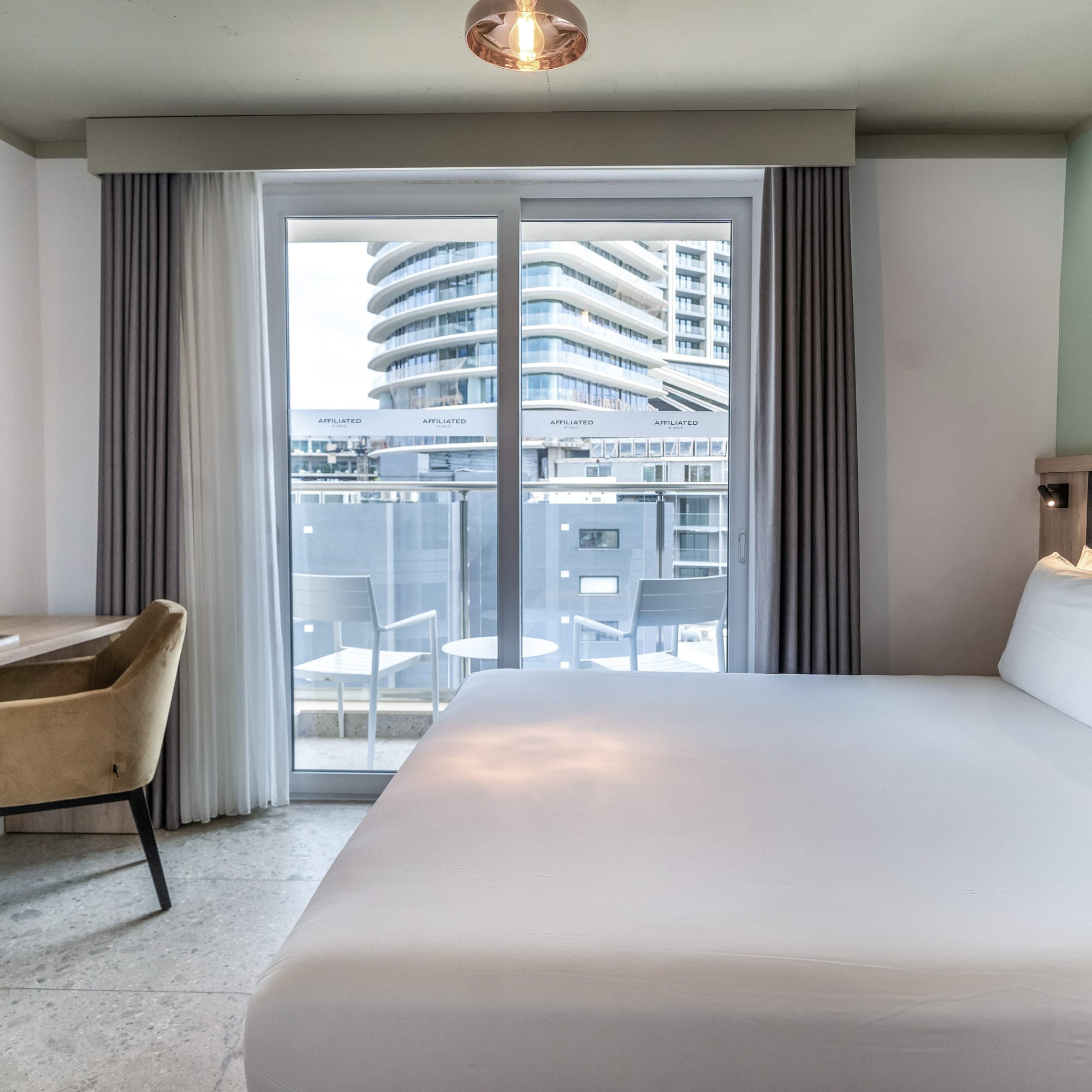 a bed in a room with a glass door