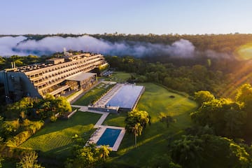 a building with a pool and trees