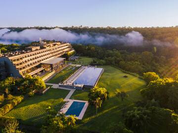 a building with a pool and trees