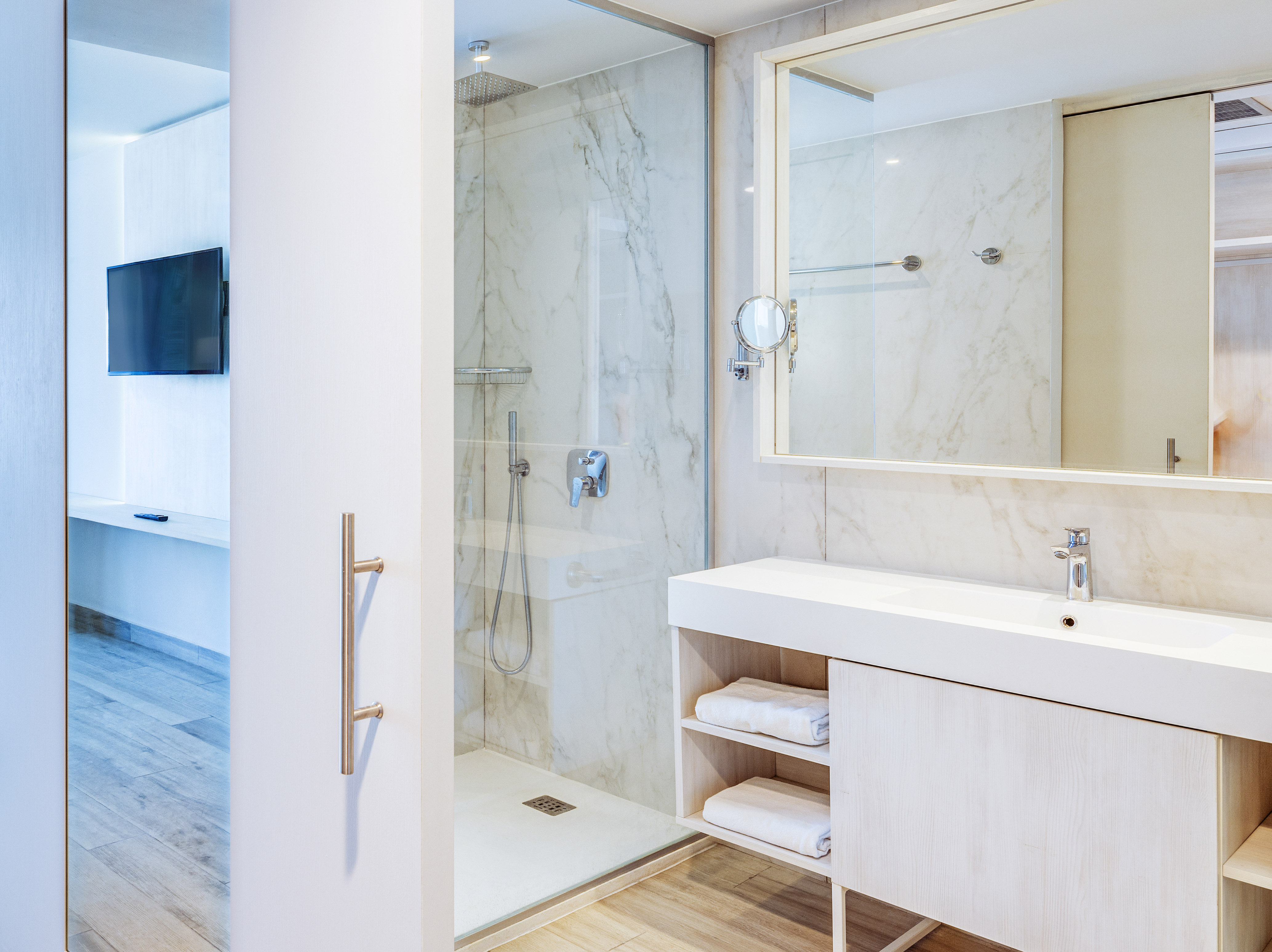a bathroom with a shower and a mirror