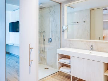 a bathroom with a shower and a mirror