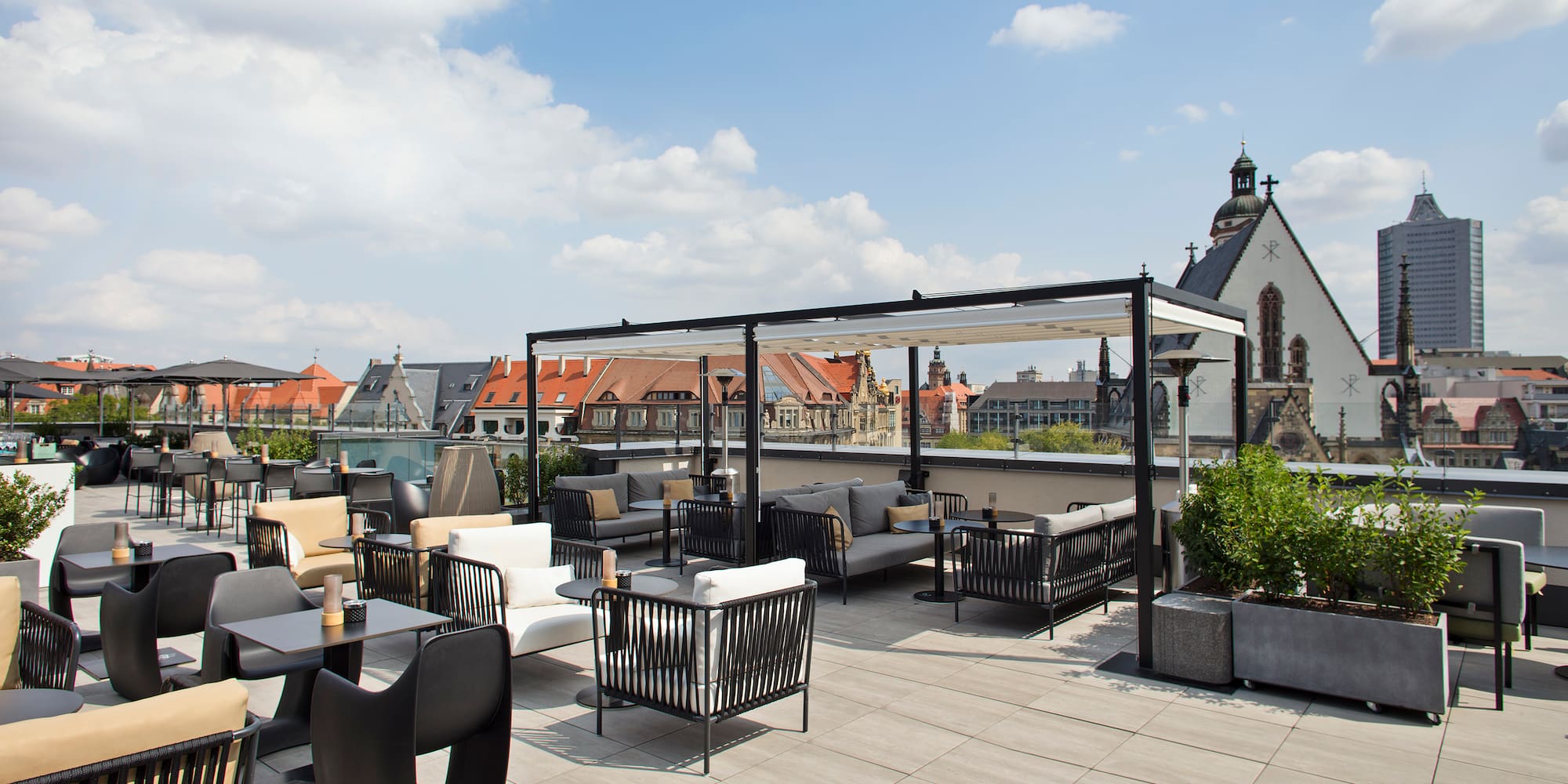 a rooftop patio with chairs and tables