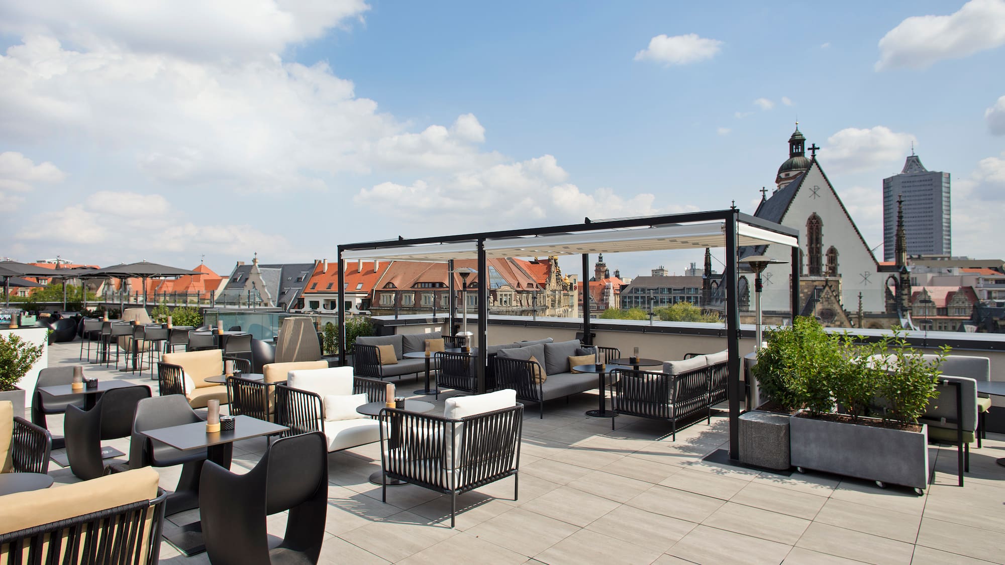 a rooftop patio with chairs and tables