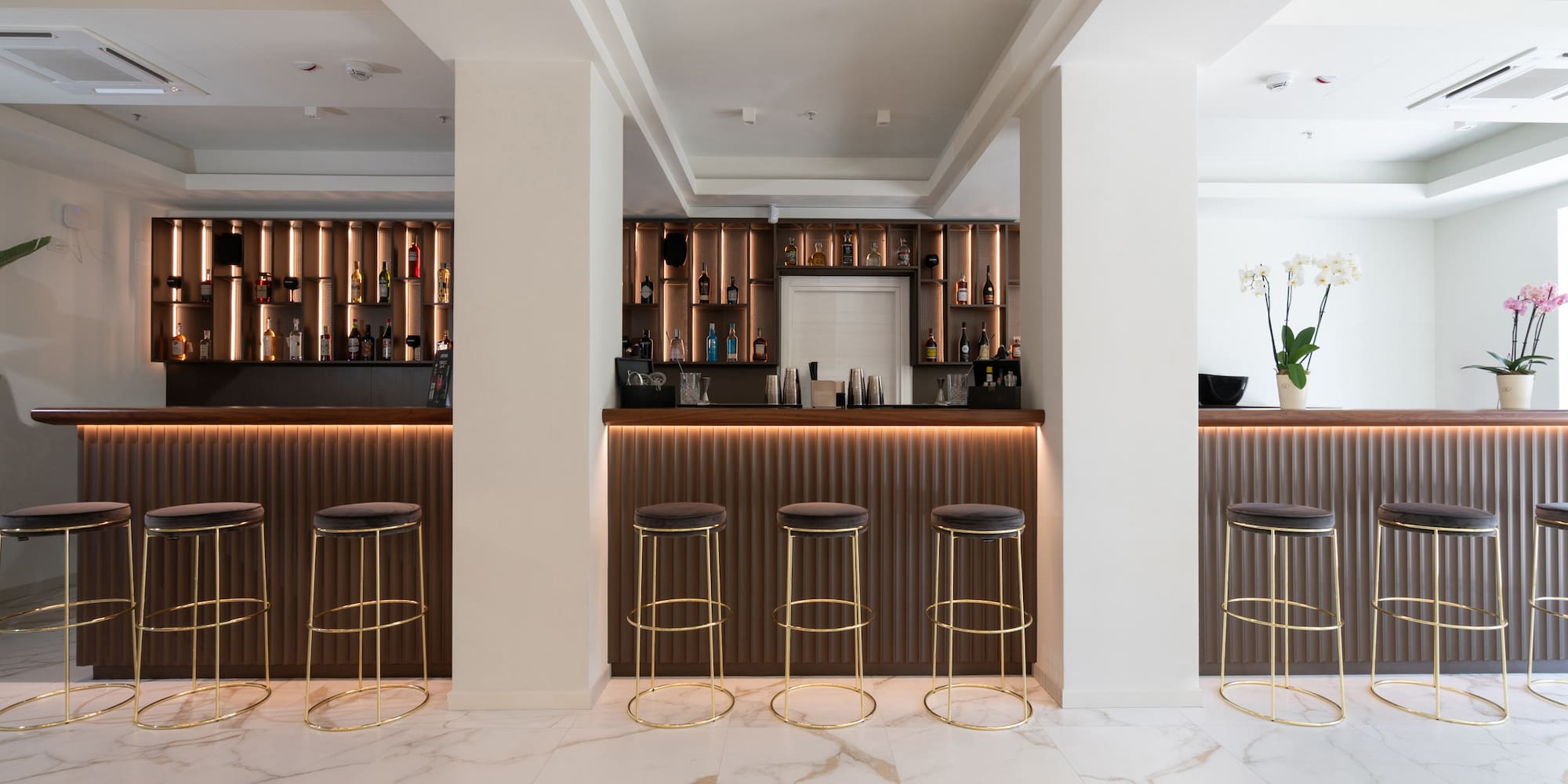 a bar with stools and shelves in a room