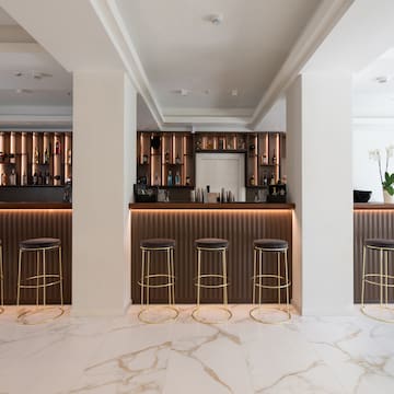a bar with stools and shelves in a room