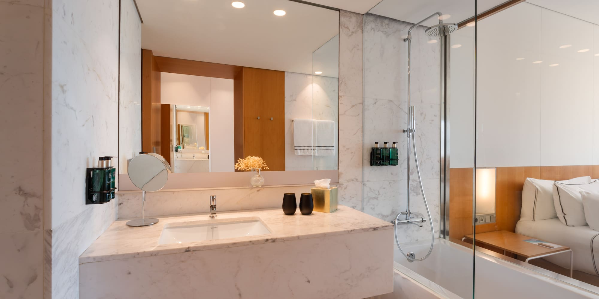 a bathroom with a marble countertop and a shower
