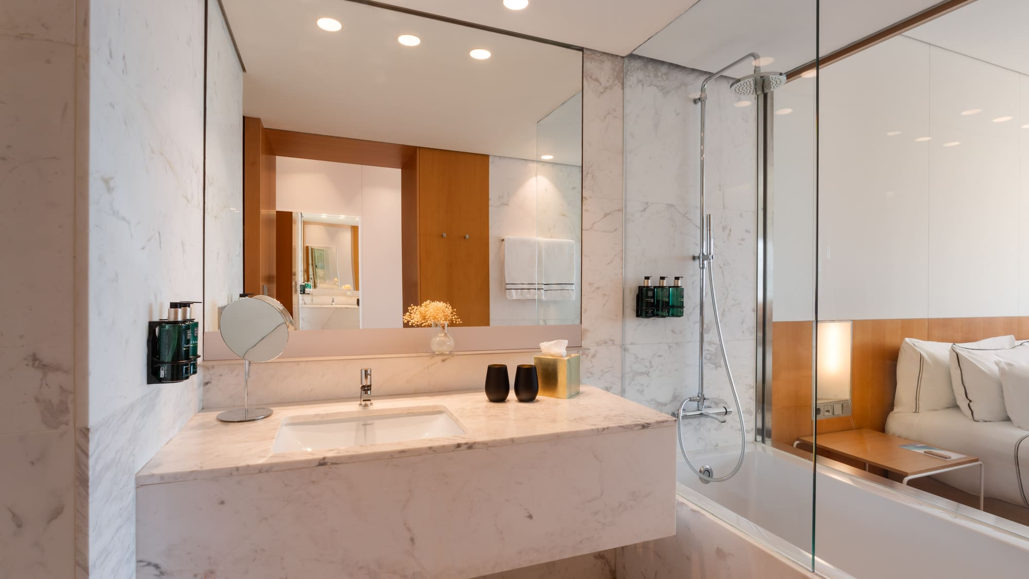 a bathroom with a marble countertop and a shower