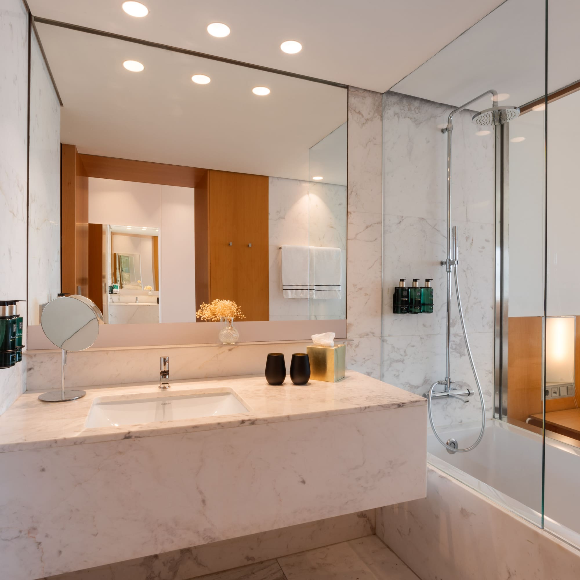 a bathroom with a marble countertop and a shower