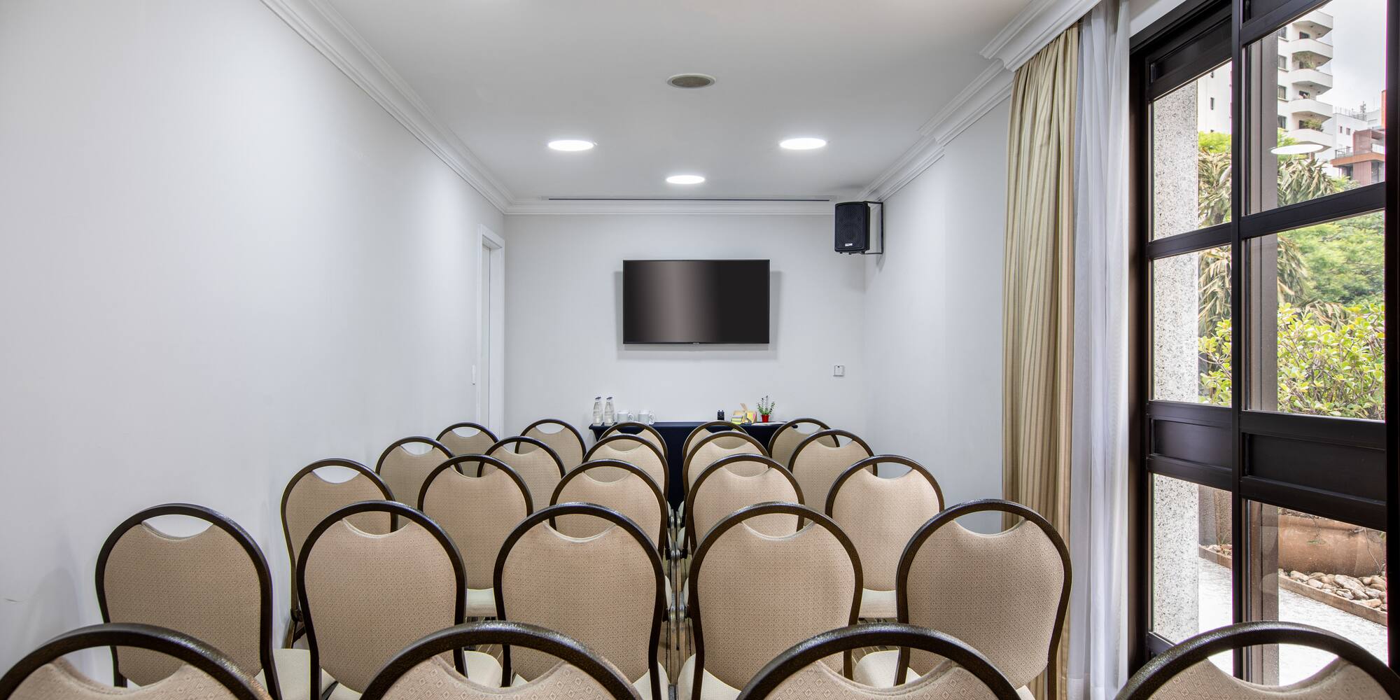 a room with chairs and a television