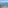 Balcony view: coastal city, expansive bay, mountains, palm trees.