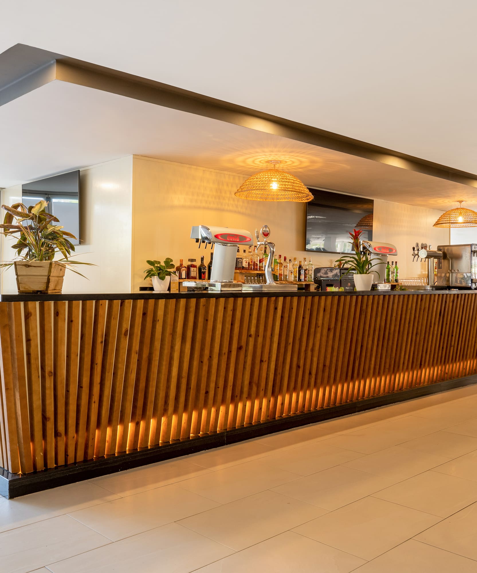 a bar with a wooden counter and plants