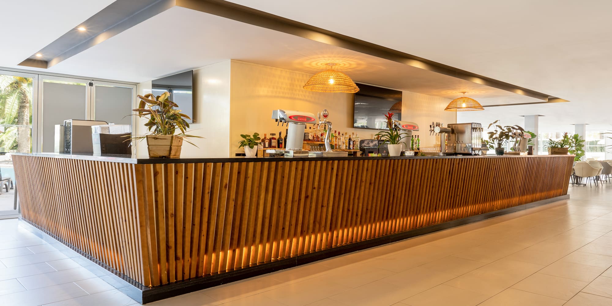 a bar with a wooden counter and plants