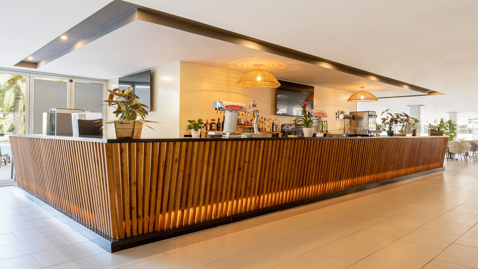 a bar with a wooden counter and plants