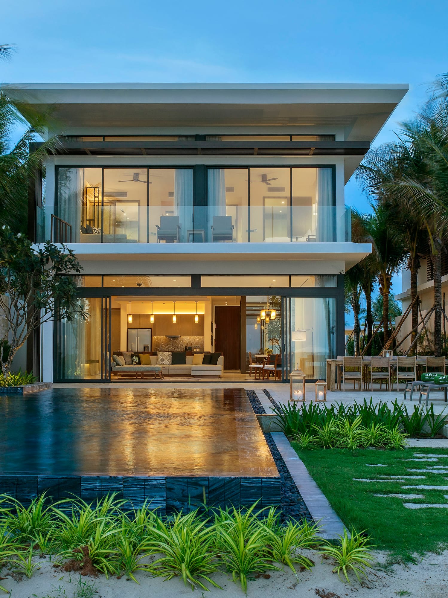 a house with a pool and palm trees