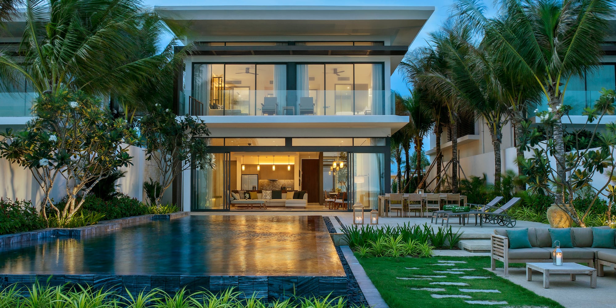 a house with a pool and palm trees