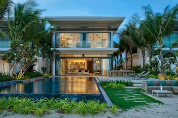a house with a pool and palm trees