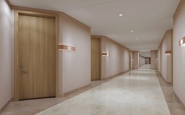 a hallway with doors and a light on the wall