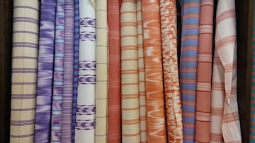 a group of colorful fabric rolls