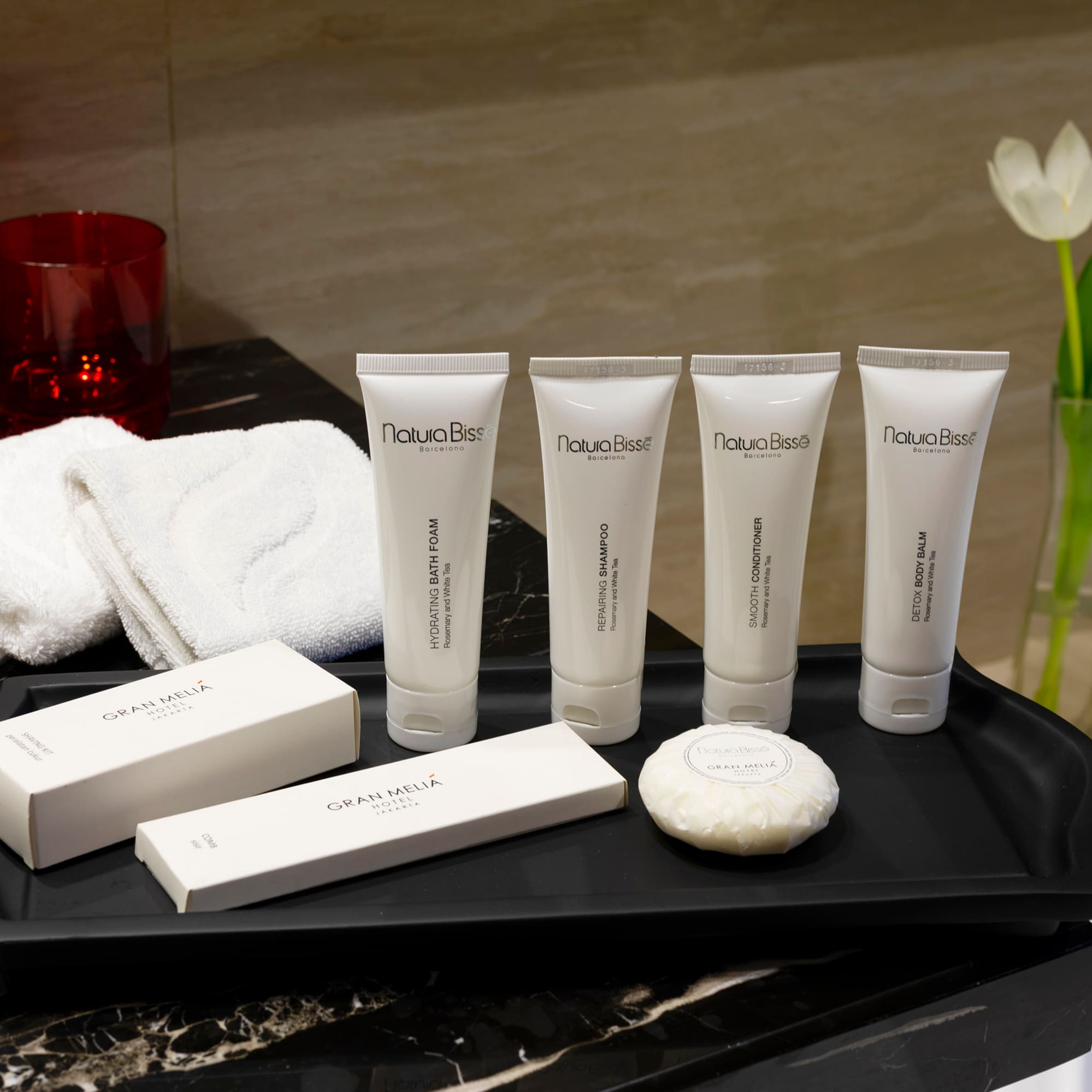 a black tray with white containers and white objects on it