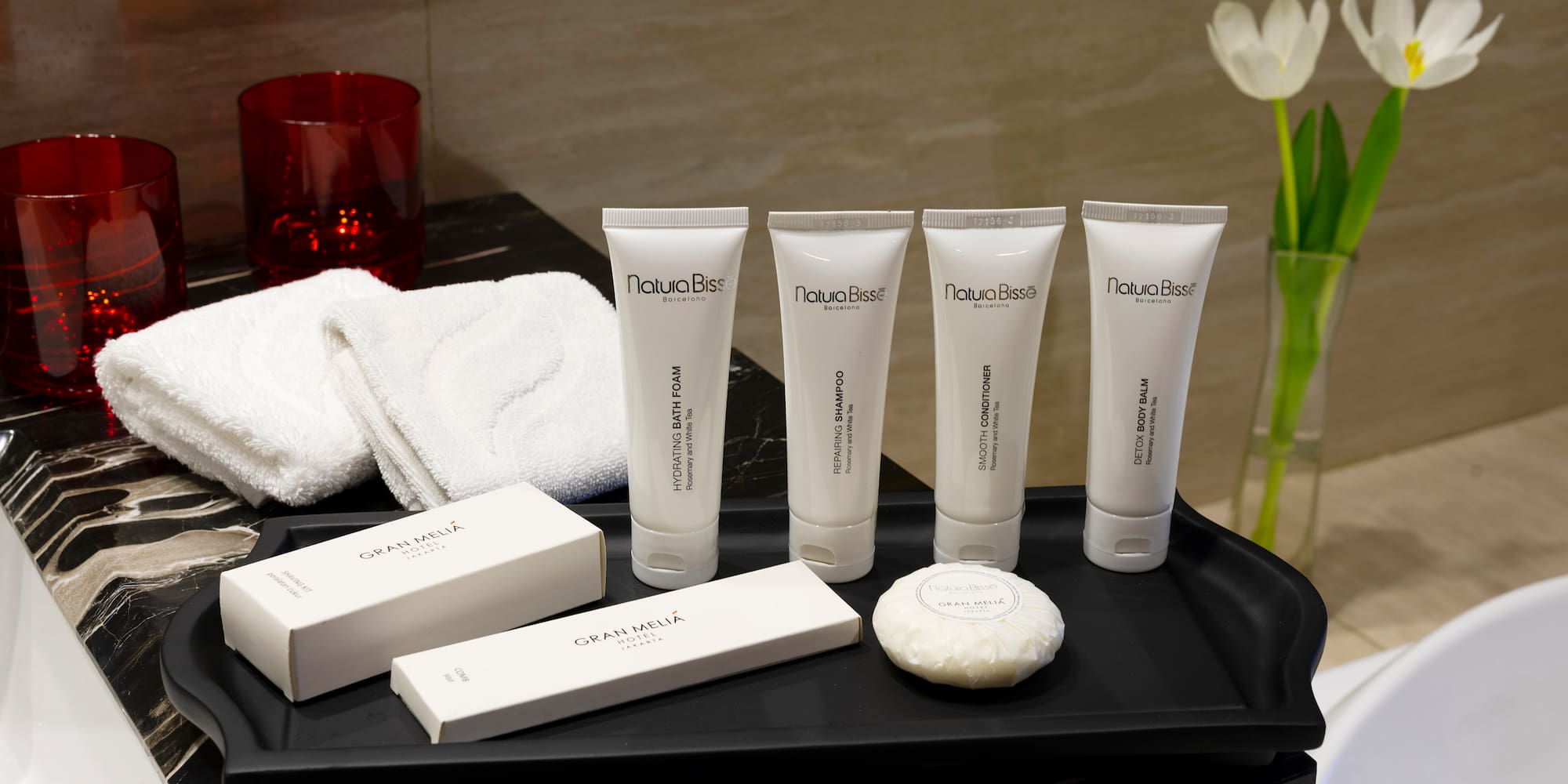 a black tray with white containers and white objects on it