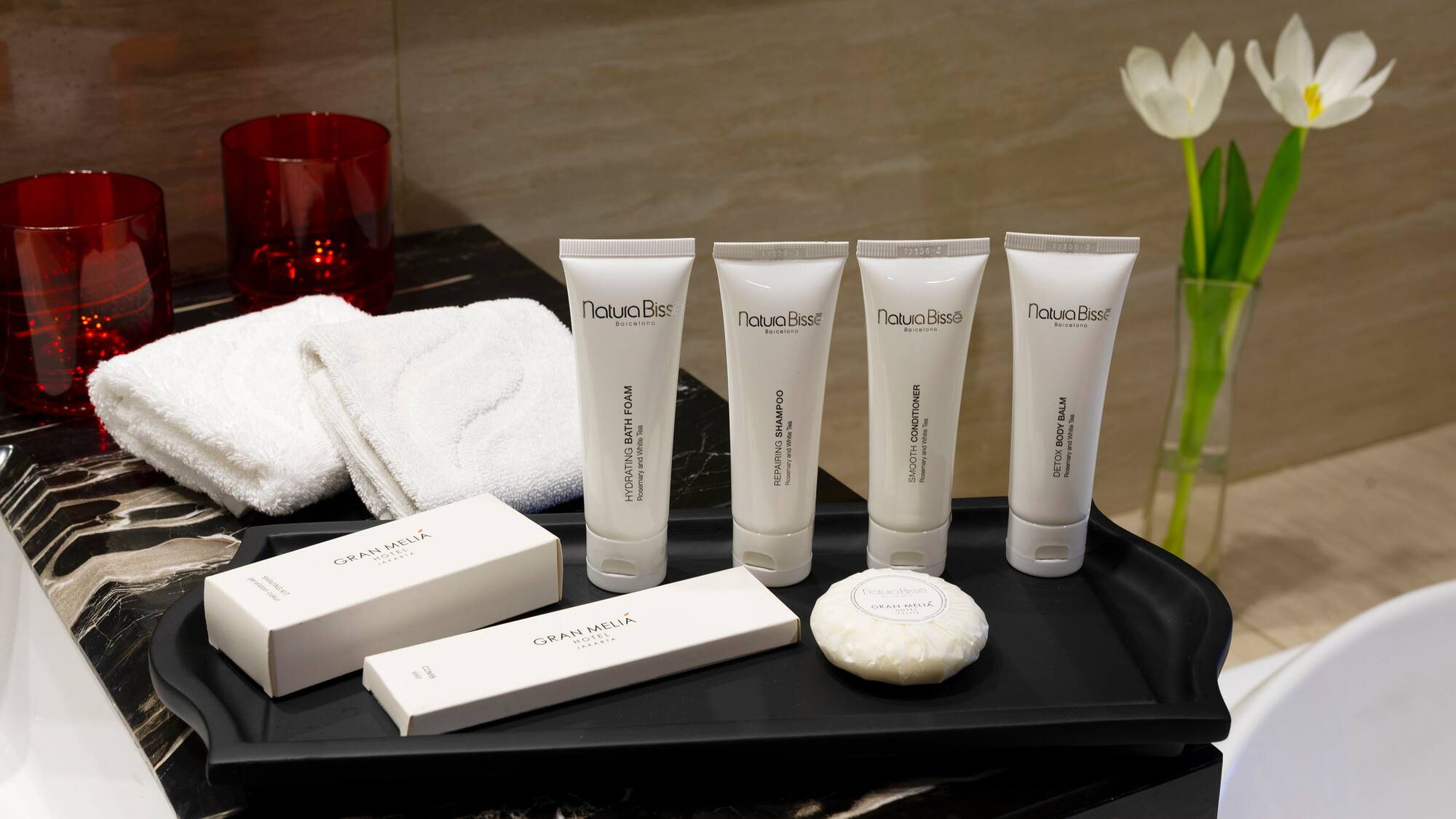 a black tray with white containers and white objects on it