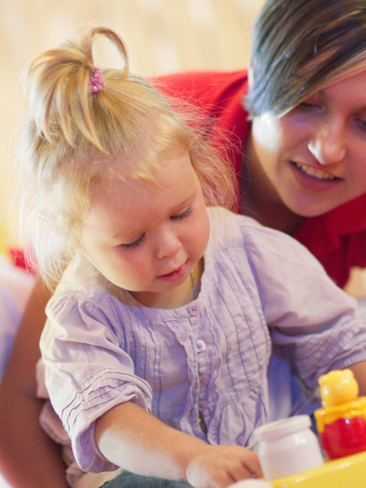 a woman and a child playing with toys