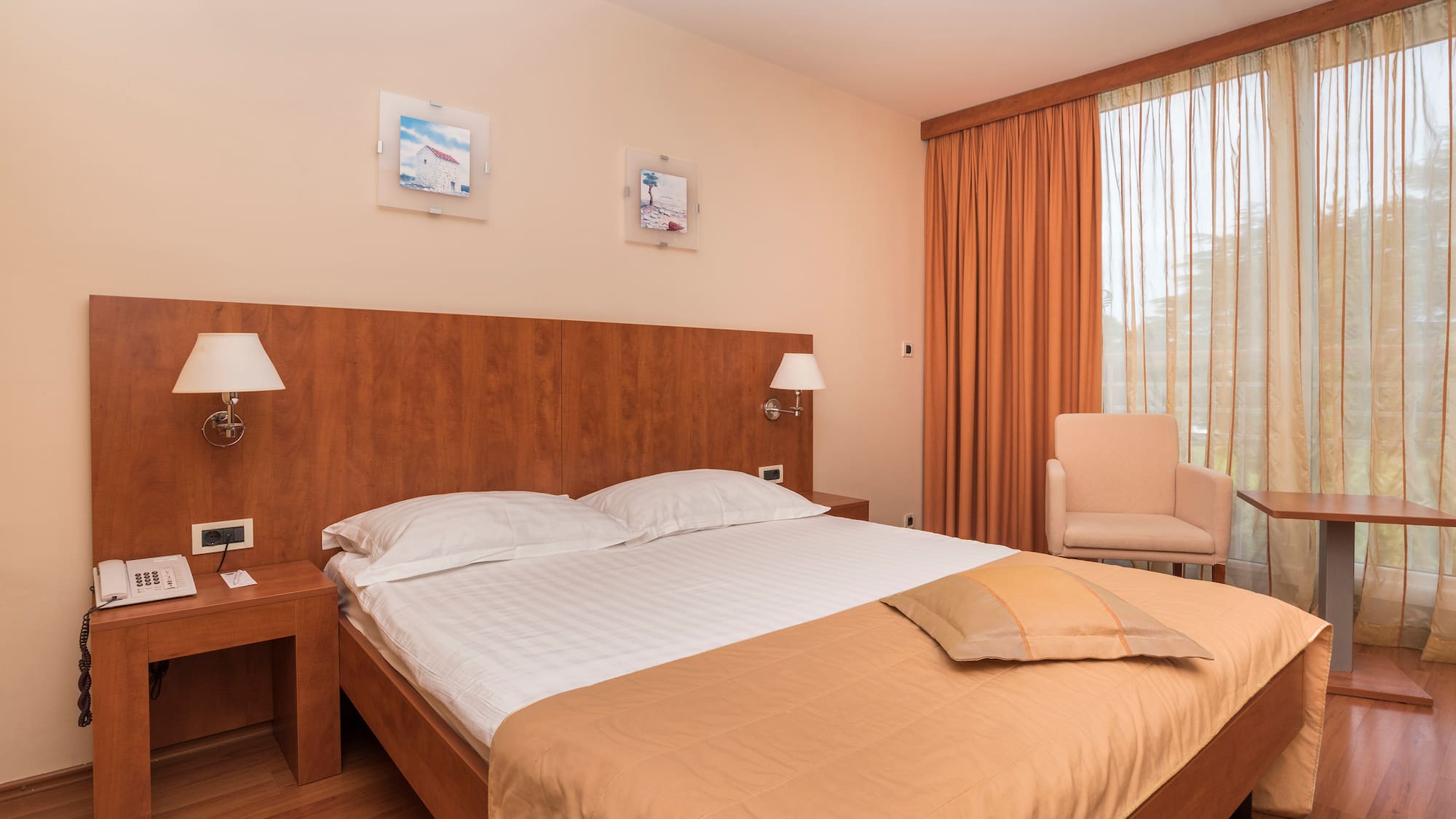 a bed with a wood headboard and a chair in a room