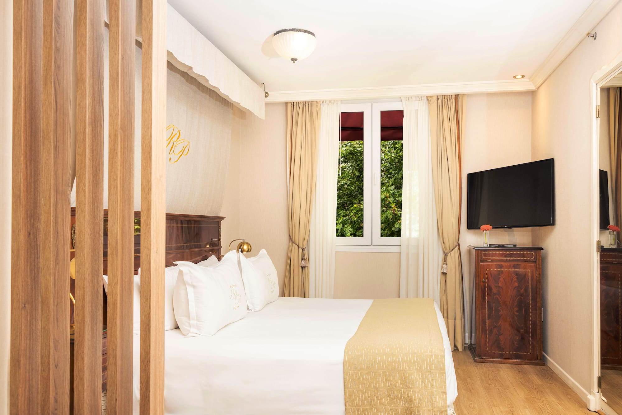 a bedroom with a bed and a television