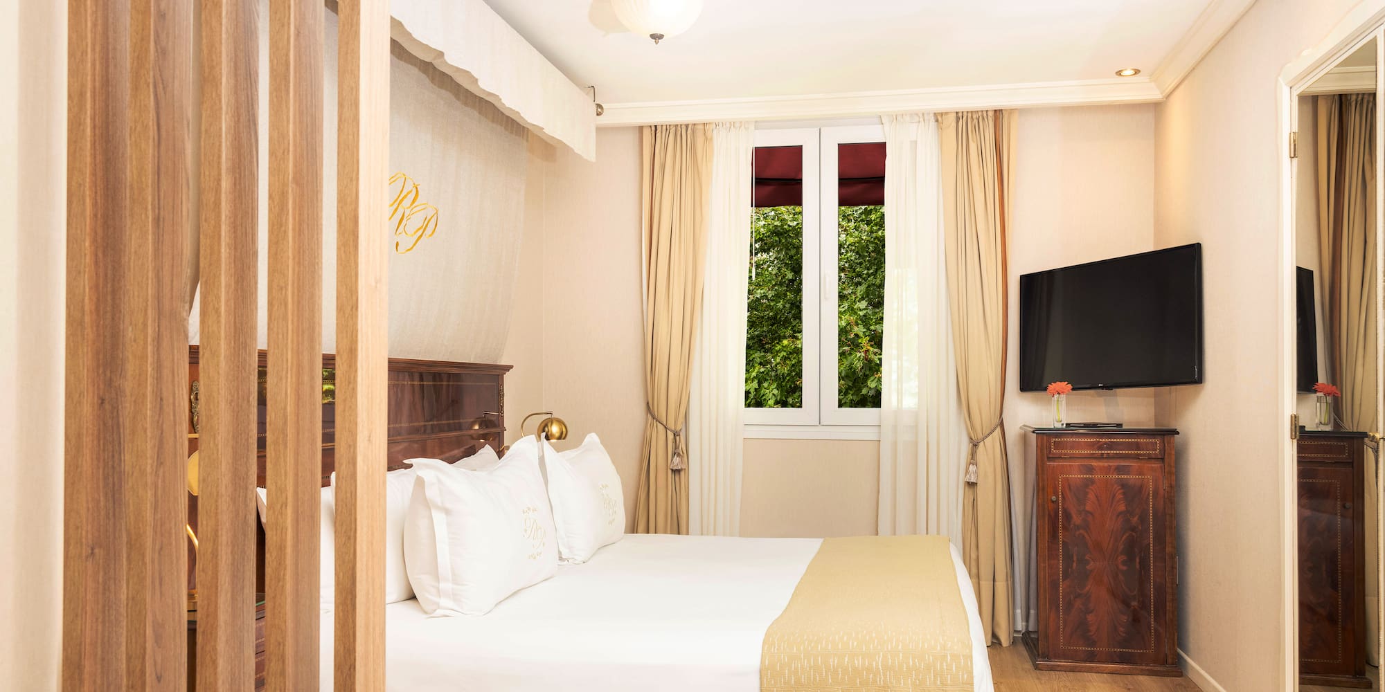 a bedroom with a bed and a television