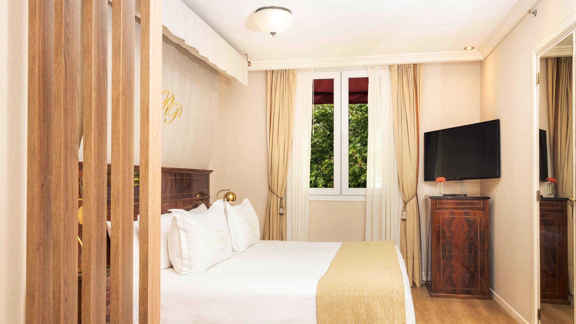 a bedroom with a bed and a television