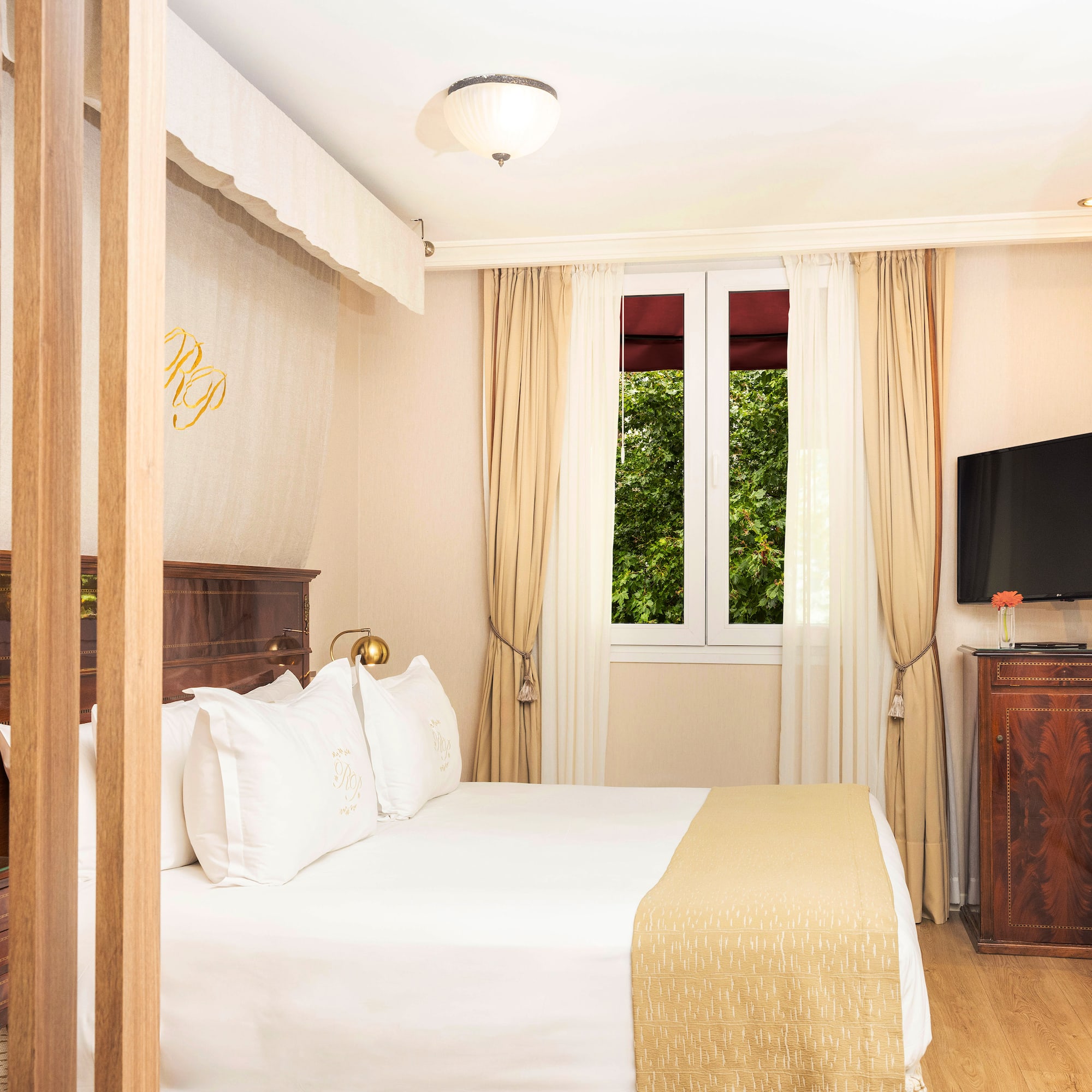 a bedroom with a bed and a television