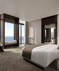 a bedroom with a large window overlooking the ocean