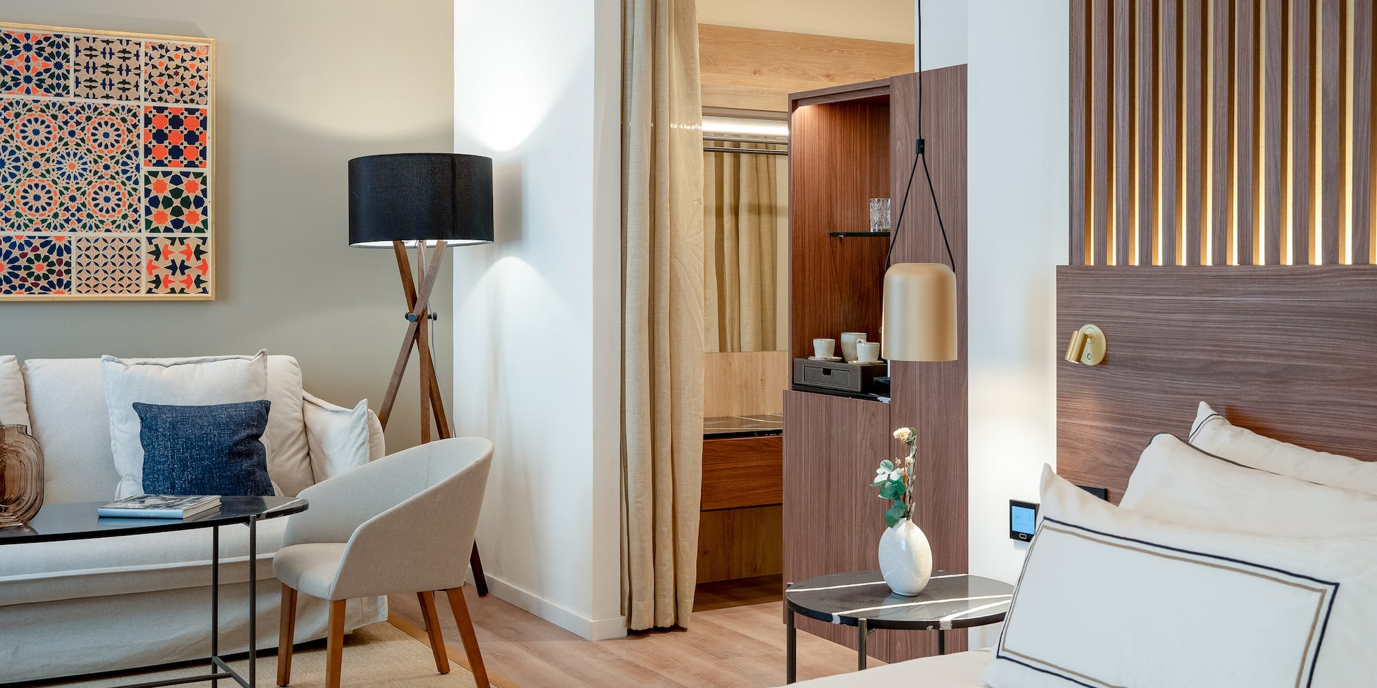 a room with a bed and a table and chairs