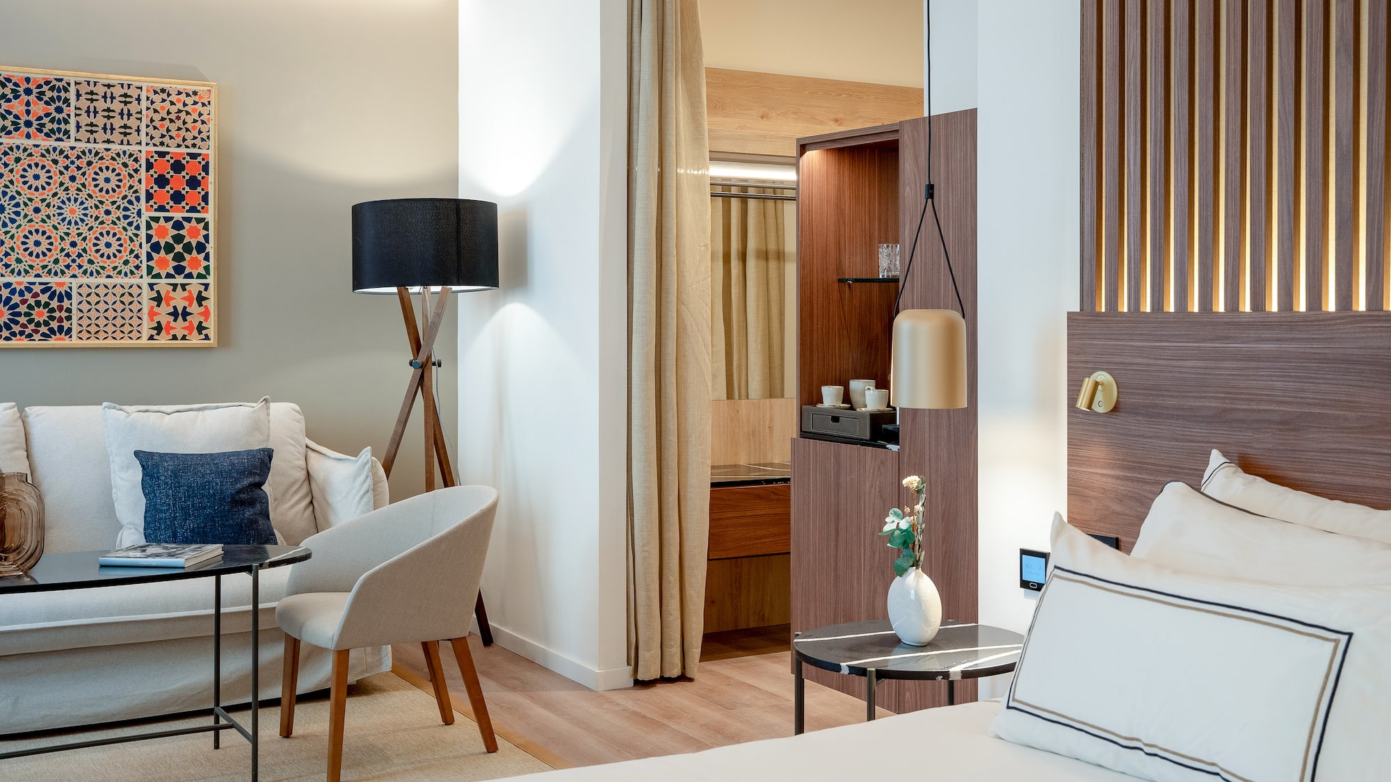 a room with a bed and a table and chairs