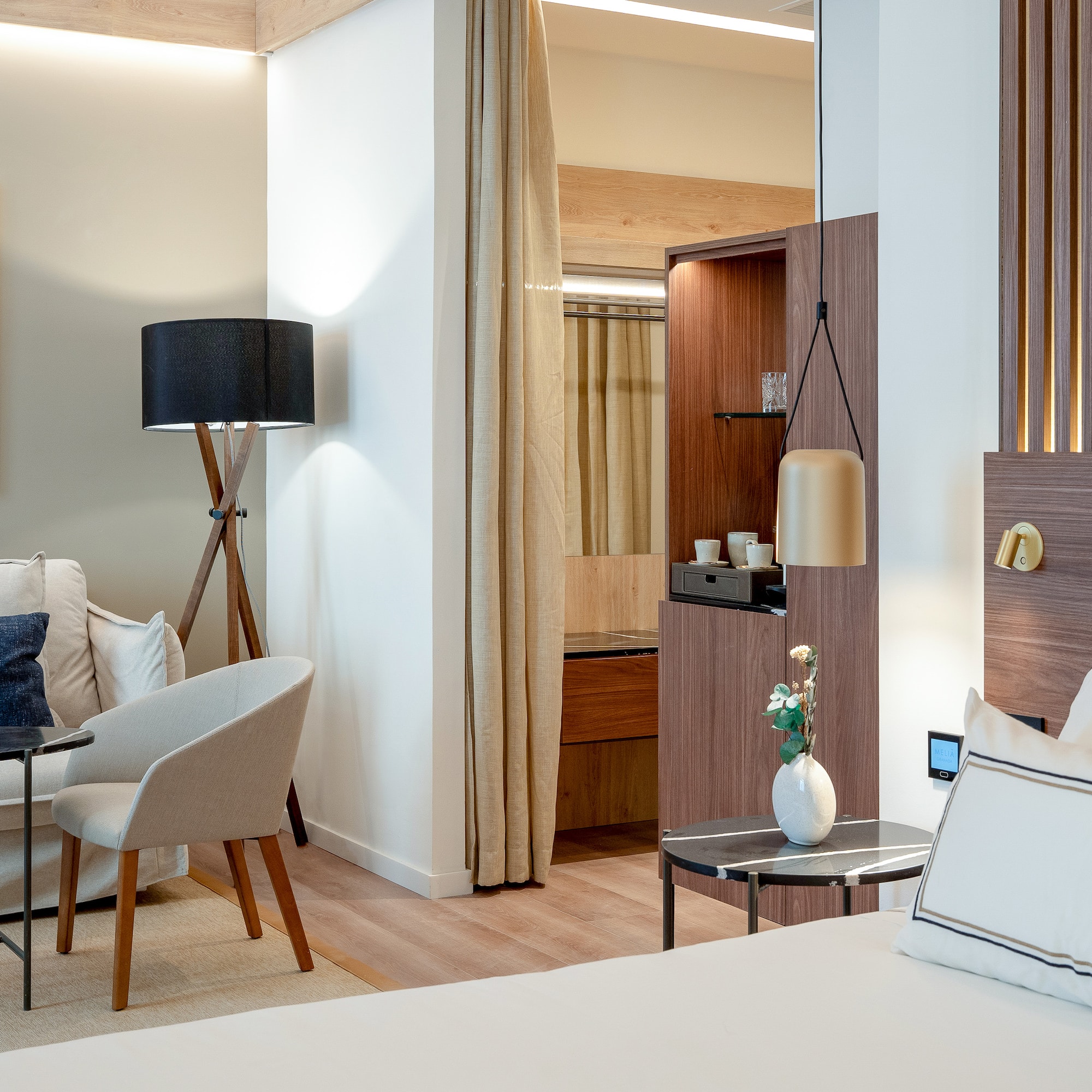 a room with a bed and a table and chairs