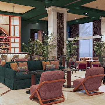 a room with a bar and chairs