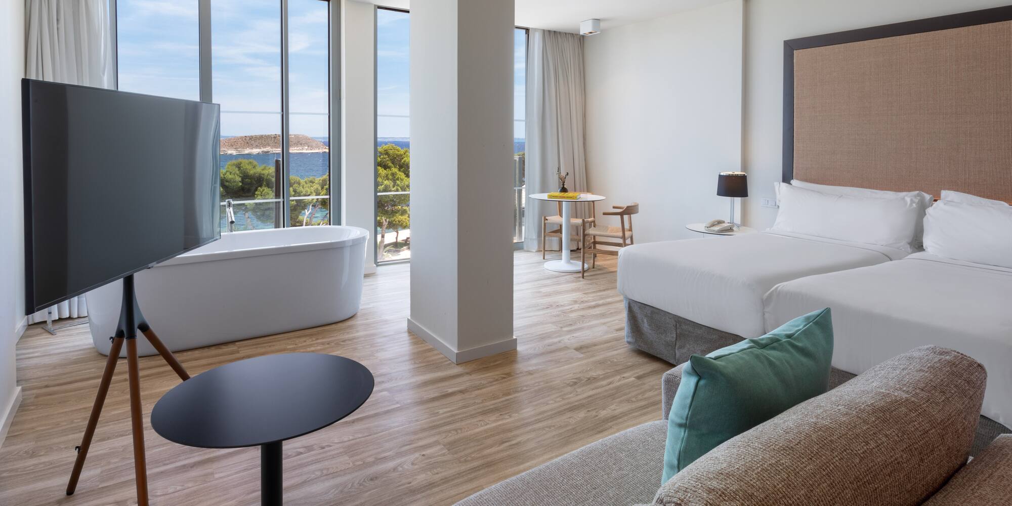 a room with two beds and a tub