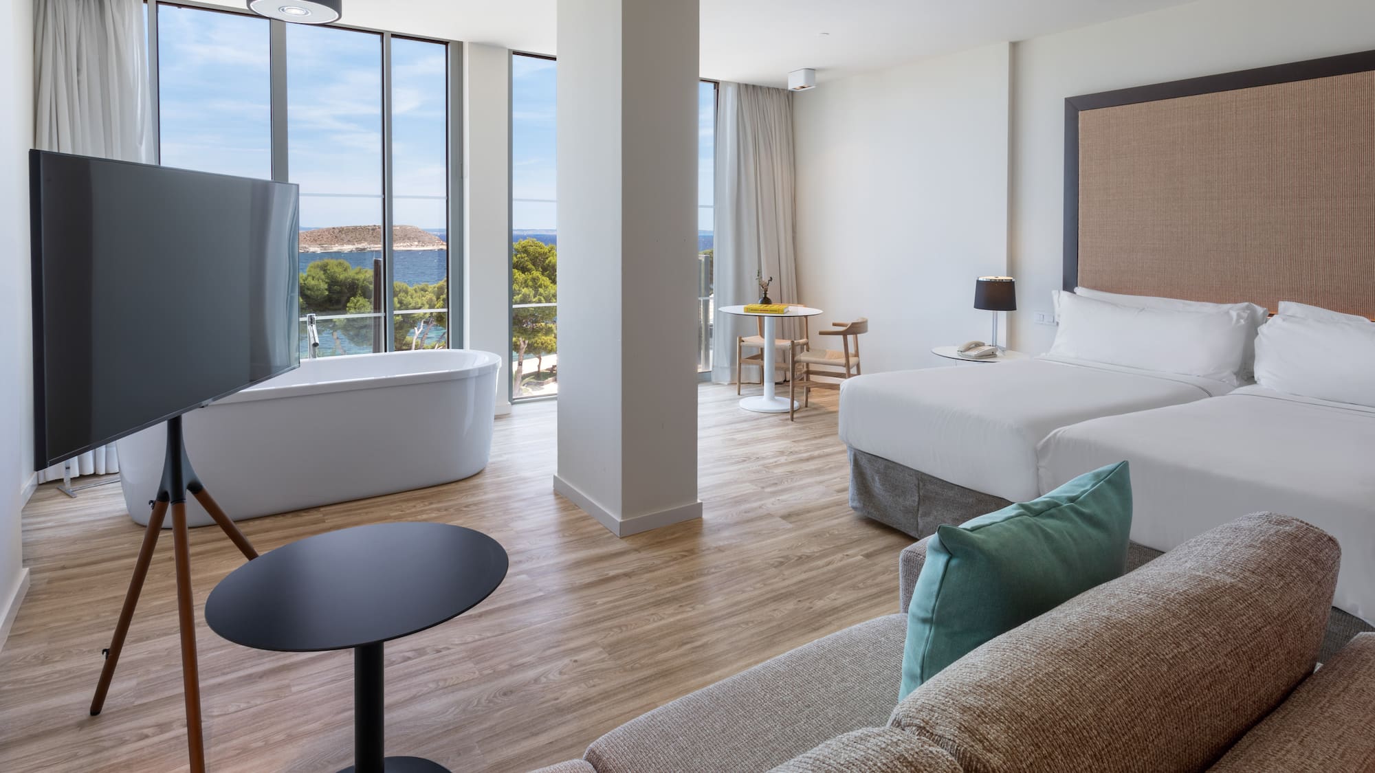 a room with two beds and a tub