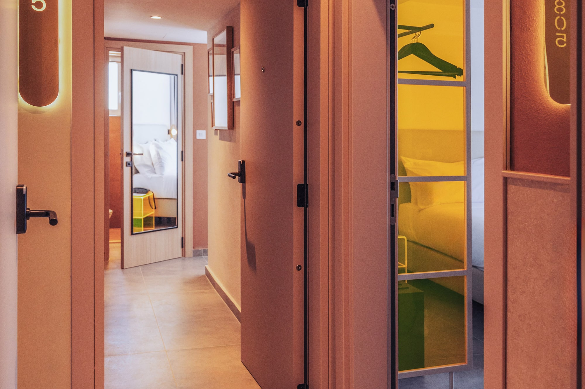 a hallway with a door open and a mirror