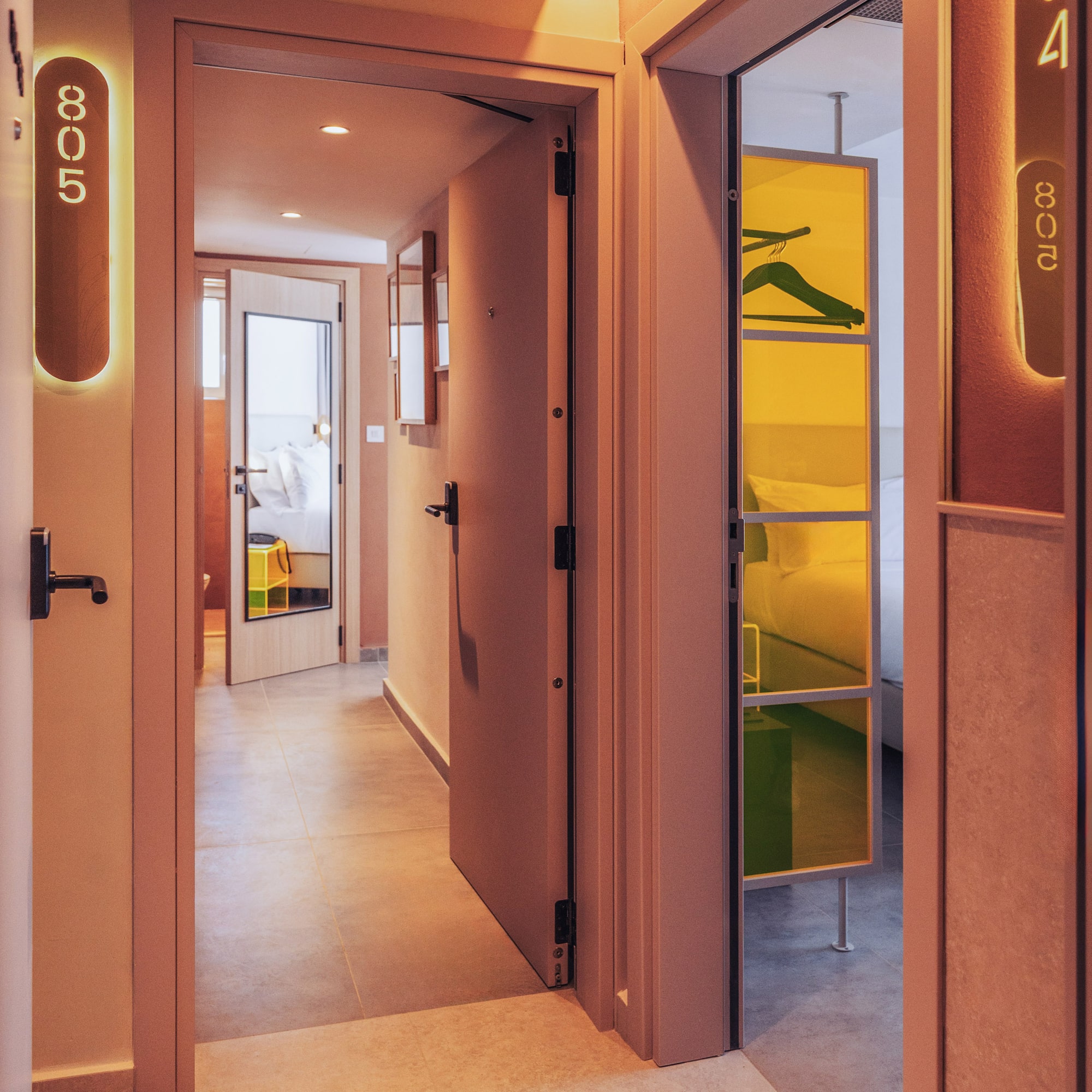 a hallway with a door open and a mirror