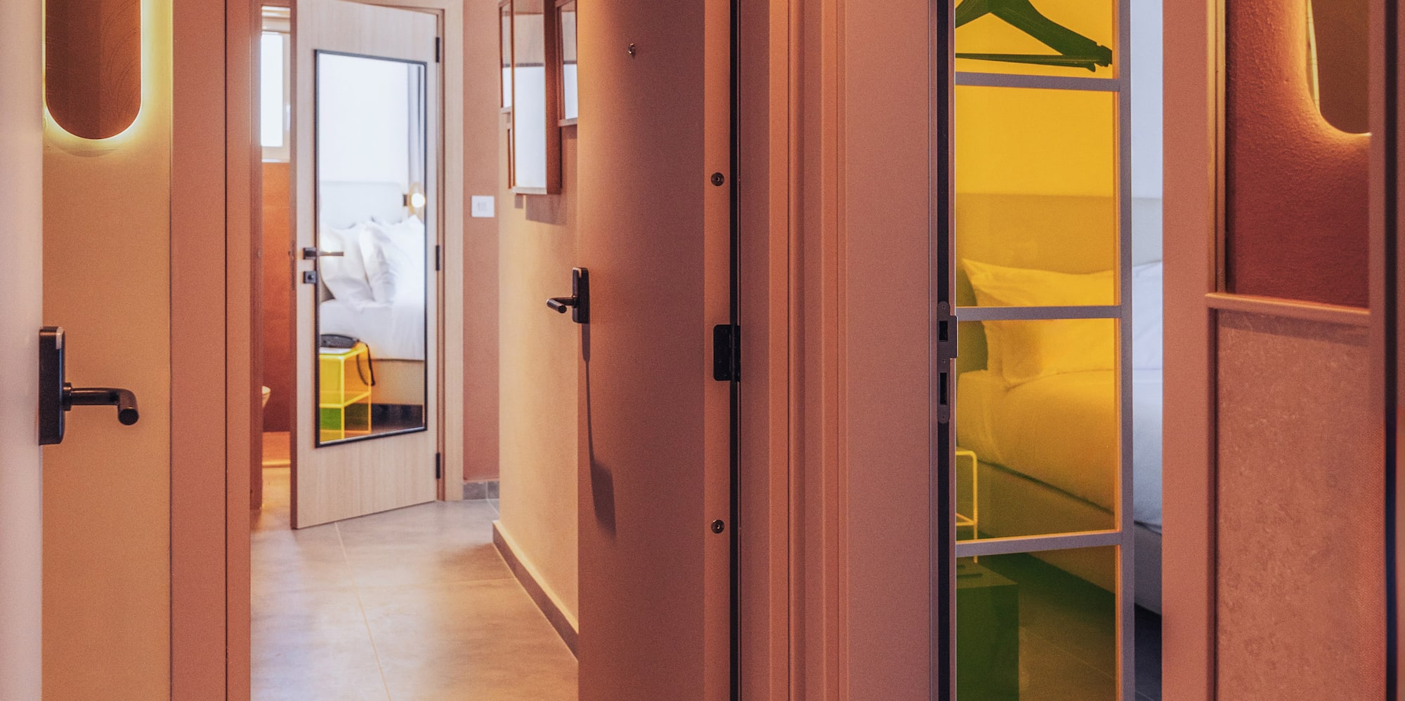 a hallway with a door open and a mirror