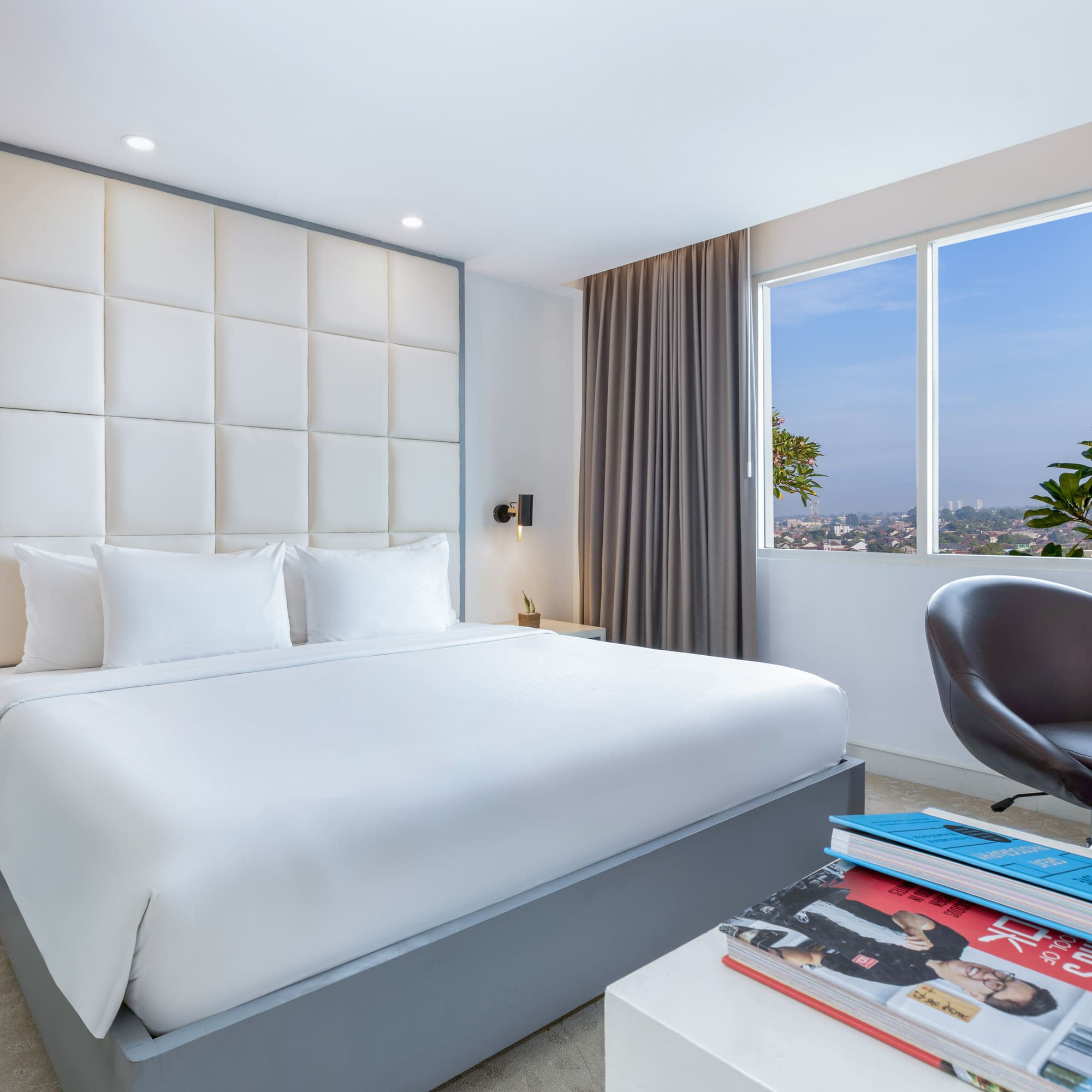 a bedroom with a bed and a chair