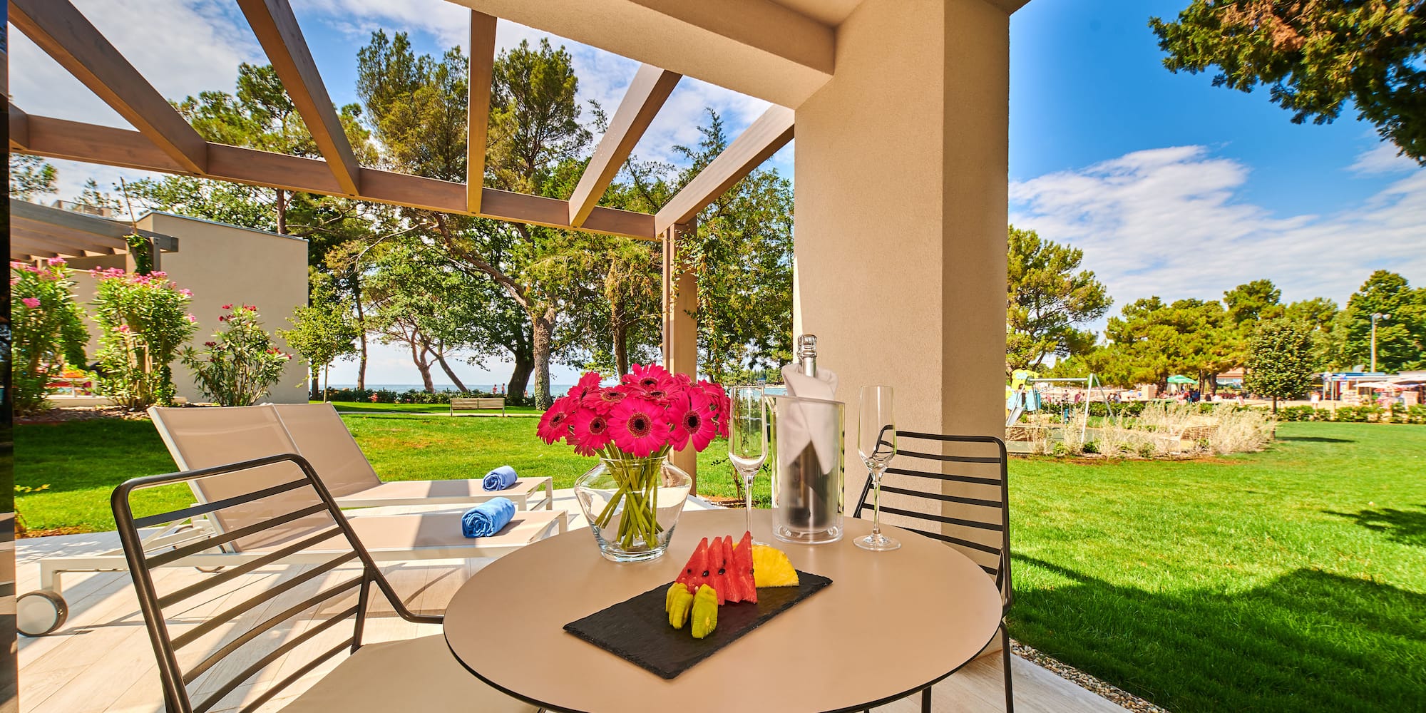 a table with fruit and wine glasses on it