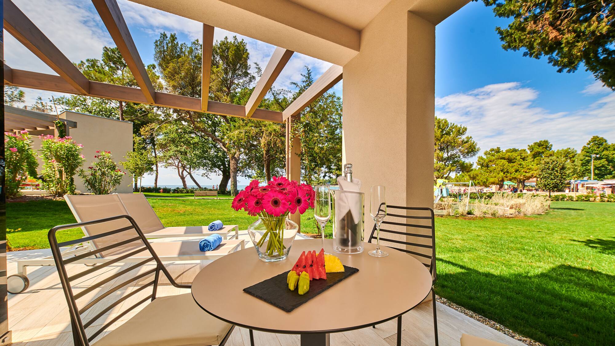 a table with fruit and wine glasses on it